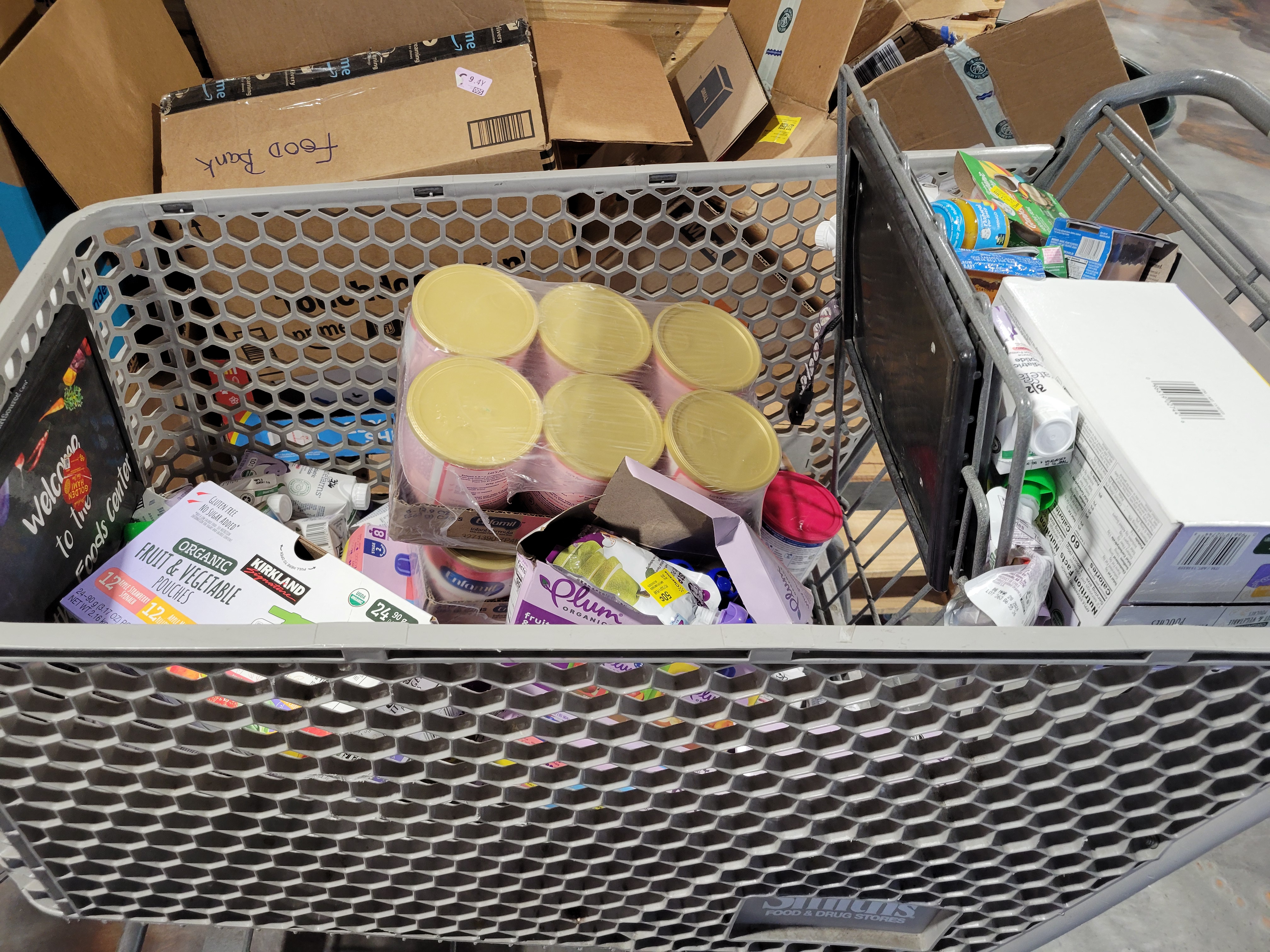 Baby supplies in a shopping cart.